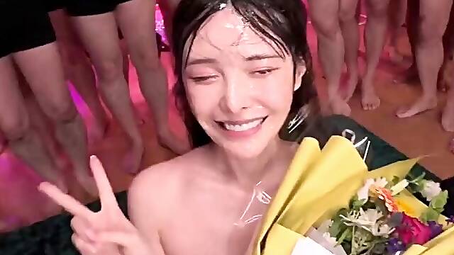 Asian slut drowning in a sea of hard cocks and hot cum