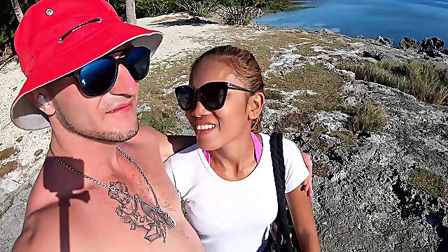 Asian babe gives a steamy blowjob on sunny beach wearing her sexy glasses